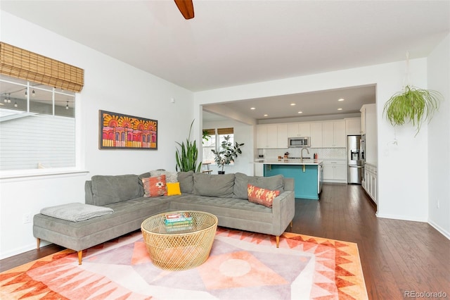 living room featuring hardwood / wood-style floors and sink