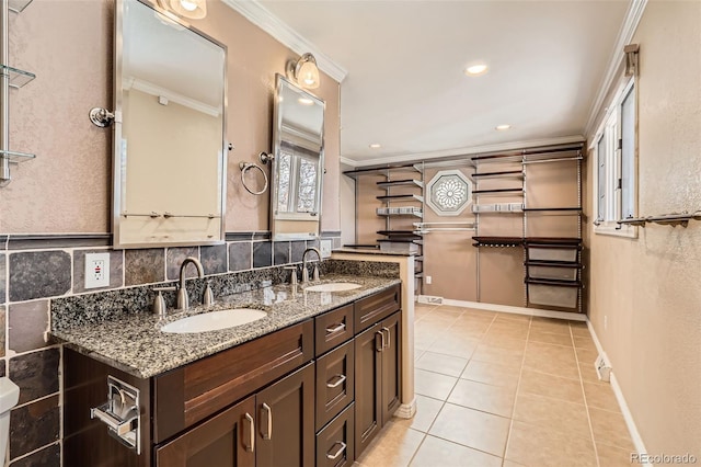 bathroom with a sink, double vanity, and crown molding
