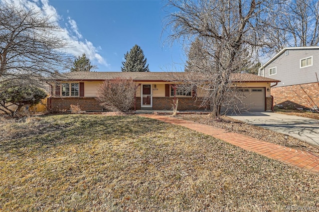 ranch-style home with concrete driveway, brick siding, a front lawn, and an attached garage