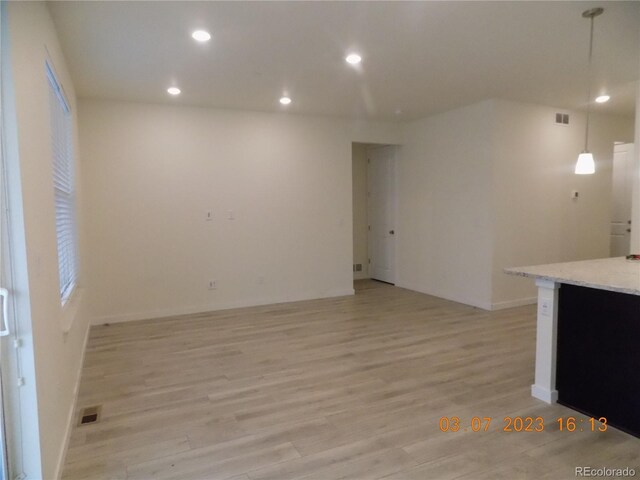 empty room featuring light wood-style flooring, recessed lighting, and visible vents