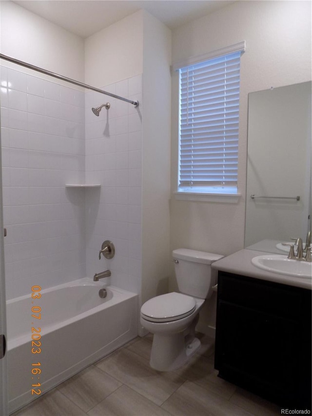 full bathroom with toilet, vanity, and washtub / shower combination