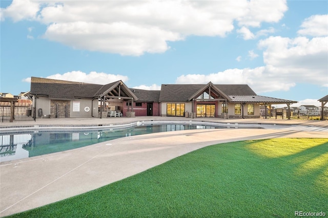 pool with a yard, a patio area, and fence