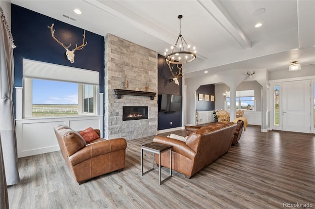 19751 Good Life Vw, Calhan, CO 80808 - living area with wood finished floors, a chandelier, beam ceiling, a fireplace, and baseboards