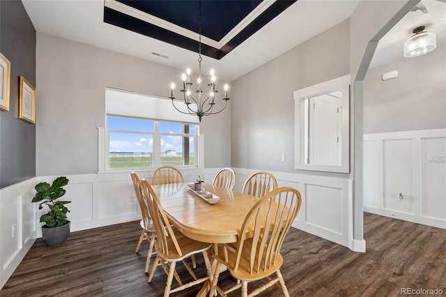 19751 Good Life Vw, Calhan, CO 80808 - dining room featuring a decorative wall, a wainscoted wall, dark wood-style floors, a chandelier, and a tray ceiling