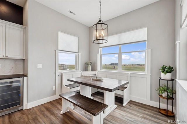 19751 Good Life Vw, Calhan, CO 80808 - dining space featuring beverage cooler, wood finished floors, a chandelier, and baseboards