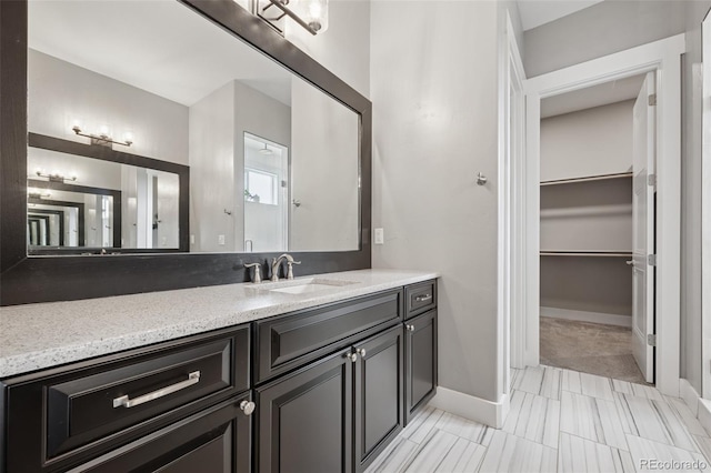 19751 Good Life Vw, Calhan, CO 80808 - bathroom featuring vanity, a spacious closet, and baseboards
