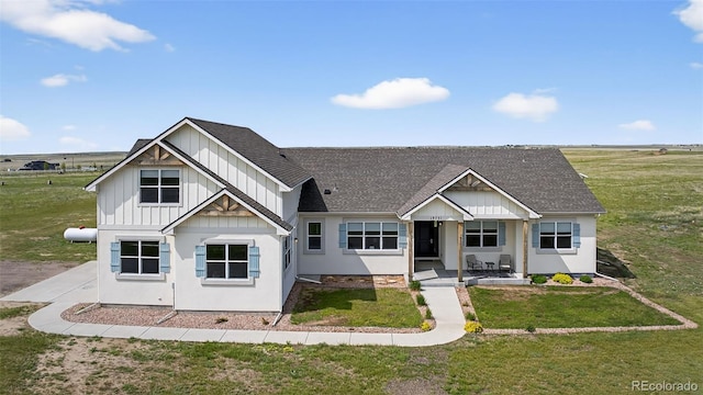 19751 Good Life Vw, Calhan, CO 80808 - modern farmhouse style home featuring roof with shingles, board and batten siding, and a front yard
