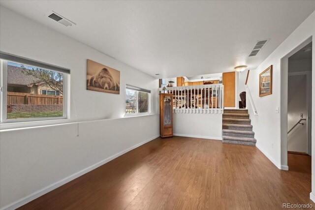 11296 Daisy Ct, Firestone, CO 80504 - spare room with wood finished floors, baseboards, and stairway