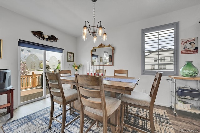 dining room featuring a chandelier and wood finished floors