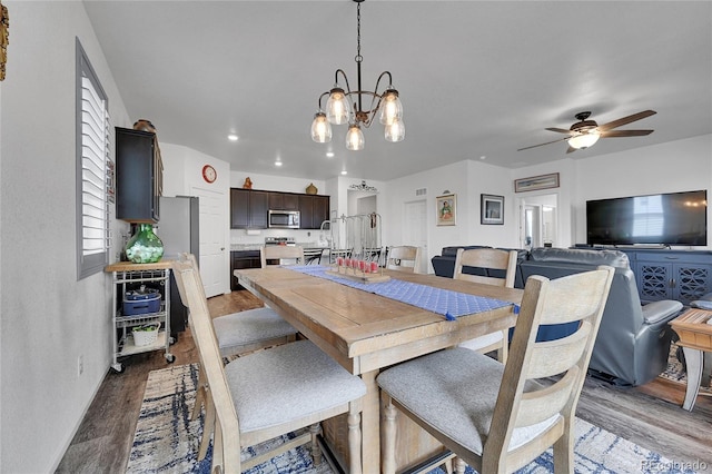dining space featuring recessed lighting, baseboards, wood finished floors, and ceiling fan with notable chandelier