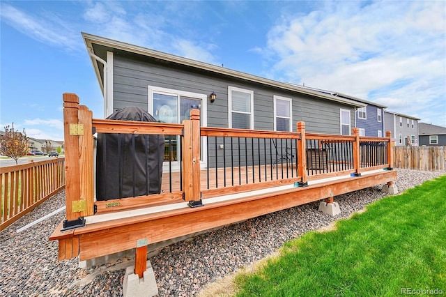 rear view of property with a wooden deck and fence