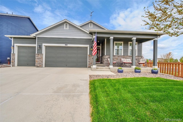 view of front facade featuring an attached garage, stone siding, a front yard, concrete driveway, and covered porch