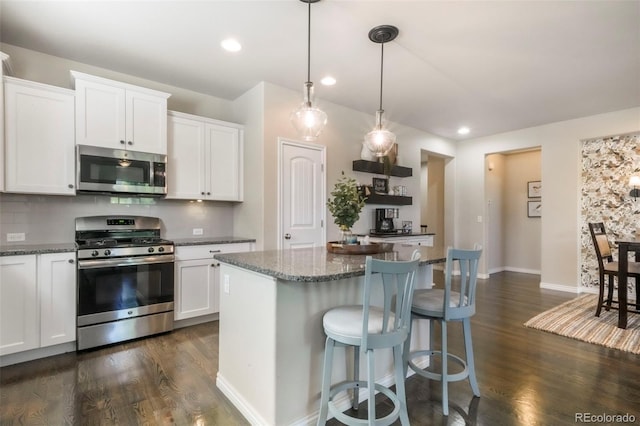 3326 Daydreamer Dr, Colorado Springs, CO 80908 - kitchen with appliances with stainless steel finishes, dark wood-style floors, white cabinetry, and recessed lighting