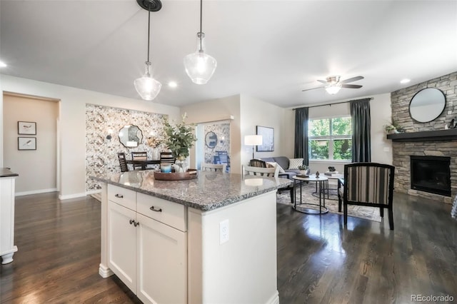 3326 Daydreamer Dr, Colorado Springs, CO 80908 - kitchen featuring open floor plan, white cabinets, a ceiling fan, light stone countertops, and dark wood-style flooring