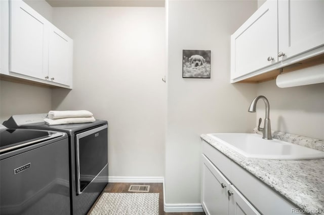 3326 Daydreamer Dr, Colorado Springs, CO 80908 - washroom featuring separate washer and dryer, cabinet space, and dark wood-style floors