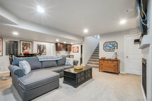 3326 Daydreamer Dr, Colorado Springs, CO 80908 - living room with bar, recessed lighting, stairs, and light carpet