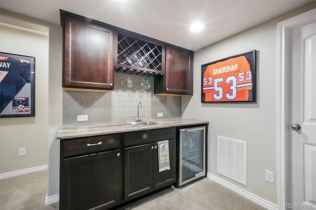 3326 Daydreamer Dr, Colorado Springs, CO 80908 - indoor wet bar with wine cooler, light carpet, and tasteful backsplash