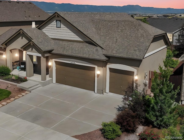 3326 Daydreamer Dr, Colorado Springs, CO 80908 - view of front of property with an attached garage, concrete driveway, a shingled roof, and stucco siding