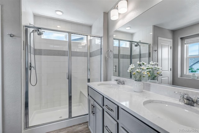 3429 Hardin St, Castle Rock, CO 80109 - bathroom featuring a shower stall, double vanity, and wood finished floors