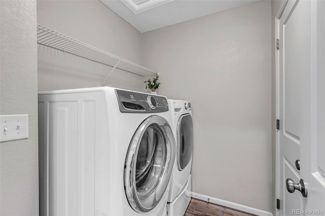 3429 Hardin St, Castle Rock, CO 80109 - washroom with separate washer and dryer, baseboards, and wood finished floors