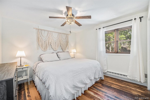 11557 Green Cir, Conifer, CO 80433 - bedroom featuring wood finished floors, a baseboard heating unit, and ceiling fan