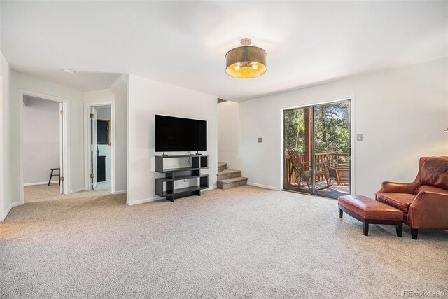 11557 Green Cir, Conifer, CO 80433 - sitting room with light carpet, stairs, and baseboards