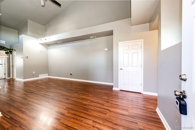 empty room featuring high vaulted ceiling, ceiling fan, and dark wood-type flooring