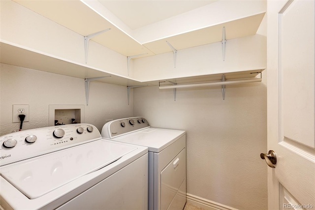 clothes washing area with washing machine and dryer