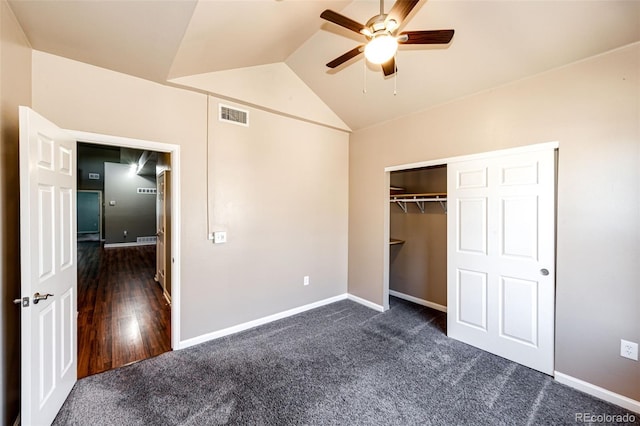 unfurnished bedroom featuring a closet, ceiling fan, dark hardwood / wood-style flooring, and vaulted ceiling