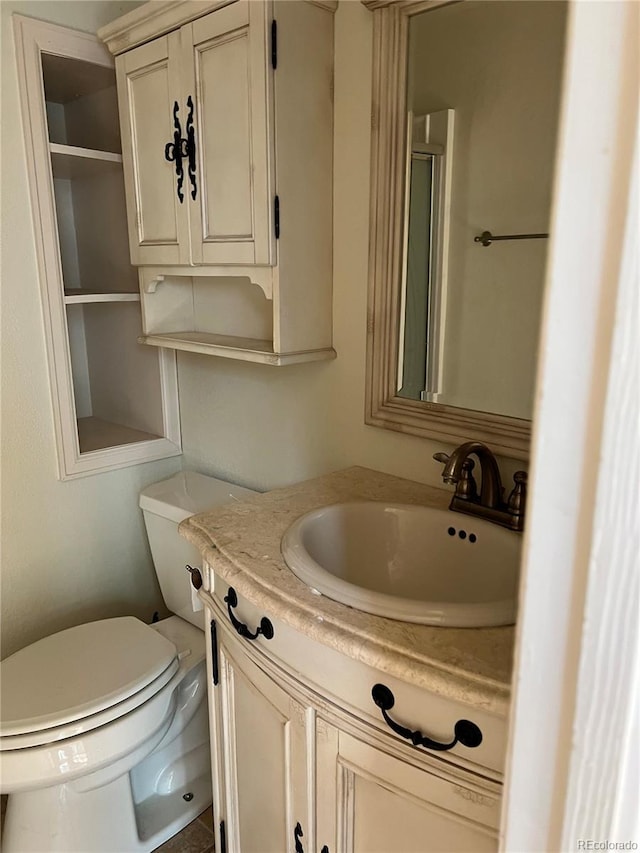 bathroom featuring oversized vanity and toilet