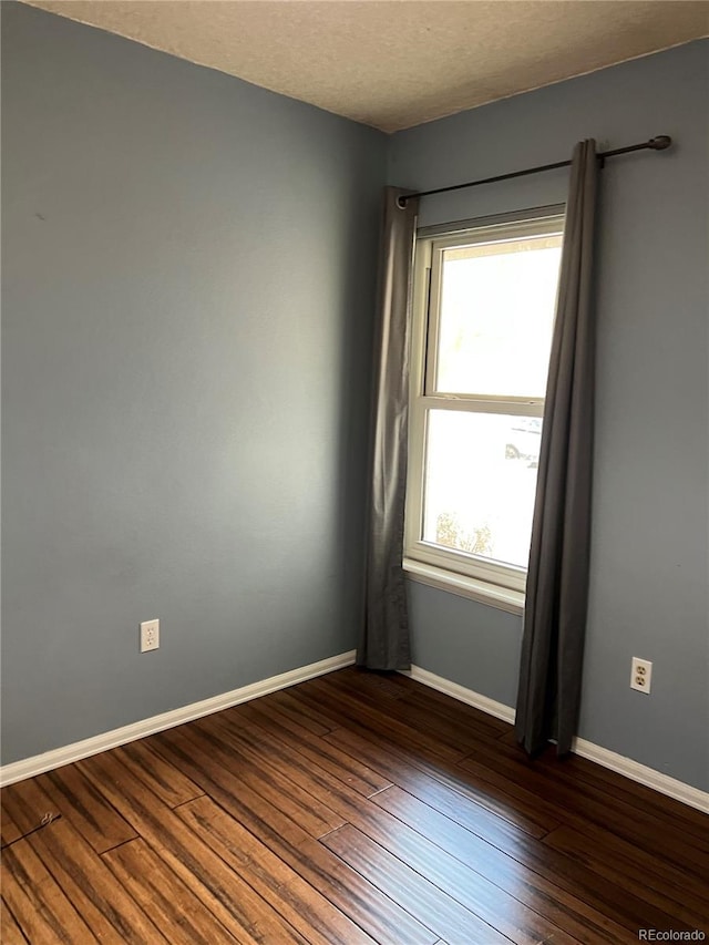 empty room featuring dark hardwood / wood-style floors