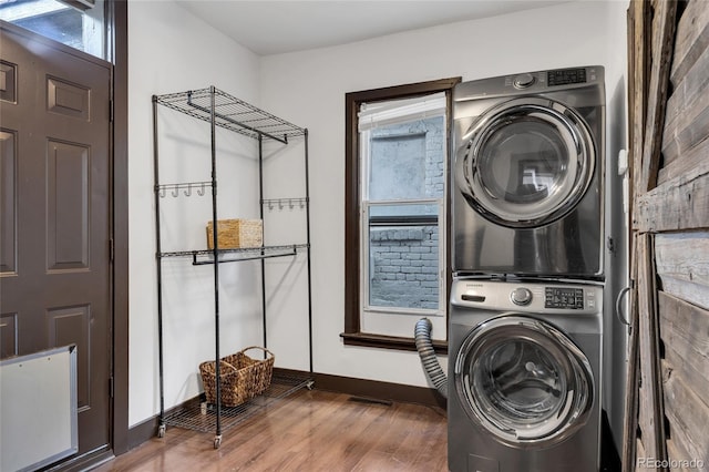 4432 Columbine St, Denver, CO 80216 - laundry room featuring stacked washing machine and dryer and wood finished floors