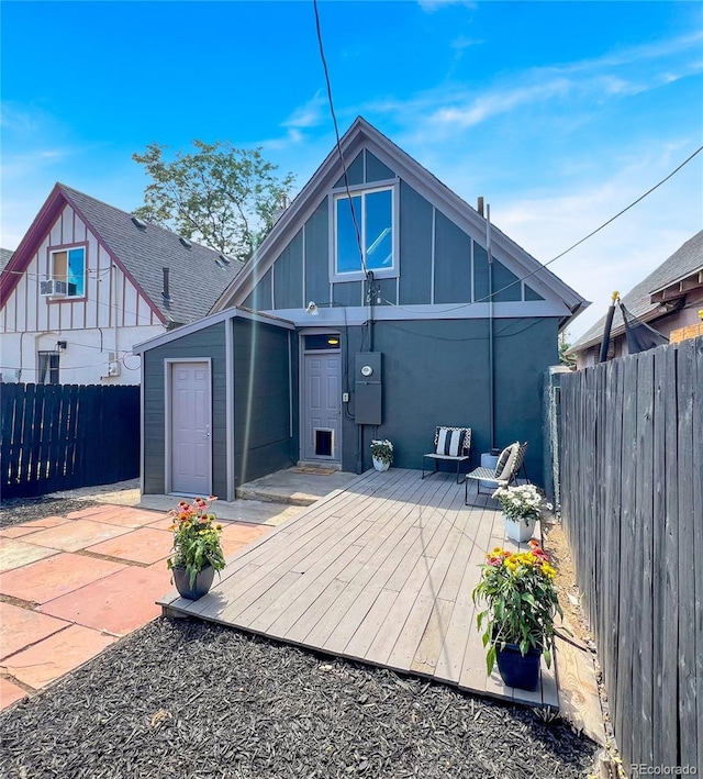 4432 Columbine St, Denver, CO 80216 - back of house with a deck, a fenced backyard, board and batten siding, and a patio