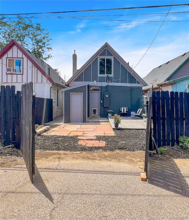 4432 Columbine St, Denver, CO 80216 - view of front of house featuring a wooden deck, a chimney, and board and batten siding