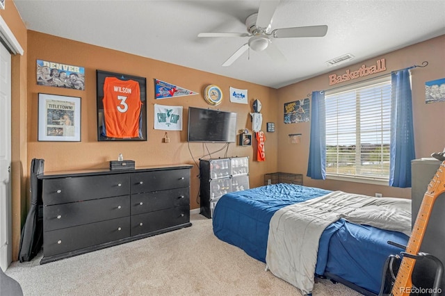 bedroom featuring a ceiling fan, visible vents, and carpet floors