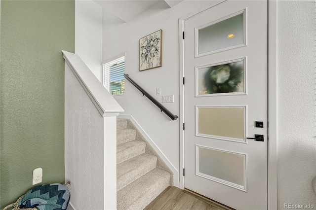 stairway featuring hardwood / wood-style floors