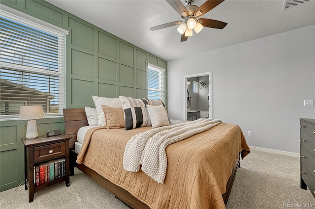 carpeted bedroom featuring ceiling fan, ensuite bathroom, and a textured ceiling