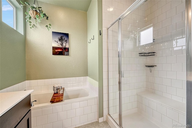 bathroom featuring vanity and independent shower and bath