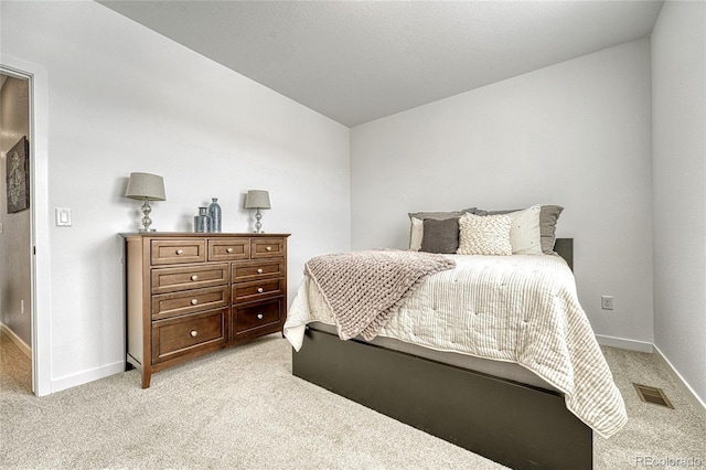 bedroom with light colored carpet