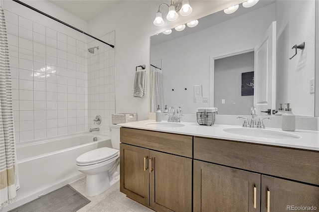 full bathroom featuring vanity, tiled shower / bath, tile patterned floors, and toilet