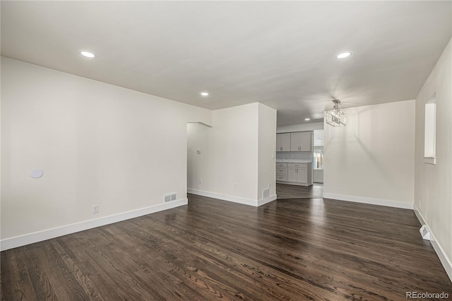 unfurnished living room featuring dark hardwood / wood-style floors