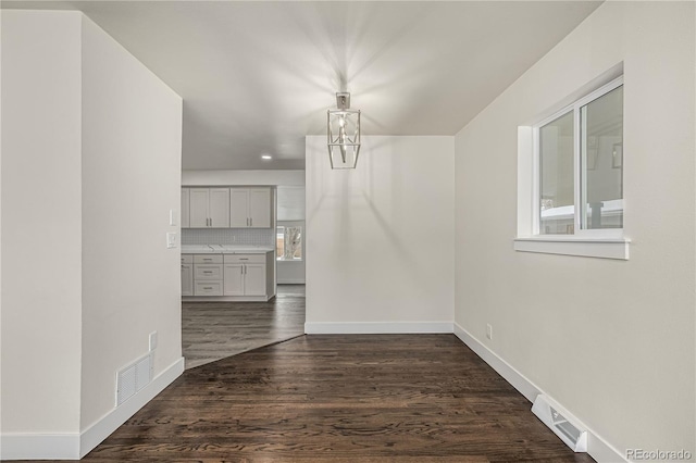 unfurnished dining area with dark hardwood / wood-style flooring