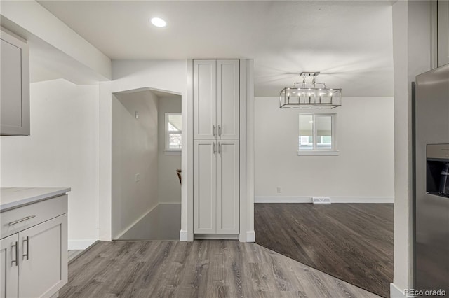 unfurnished dining area with a healthy amount of sunlight and light hardwood / wood-style floors