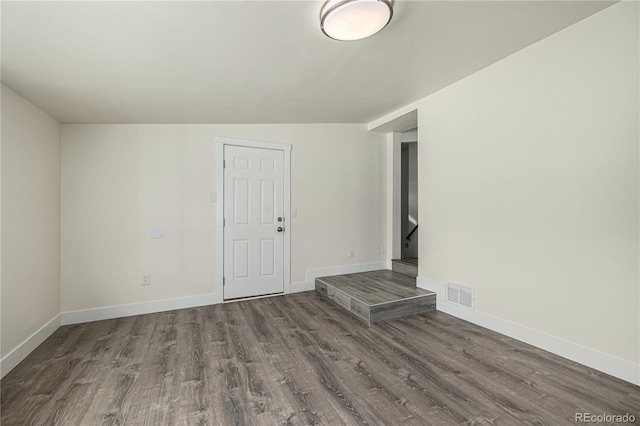 unfurnished living room with lofted ceiling and hardwood / wood-style floors