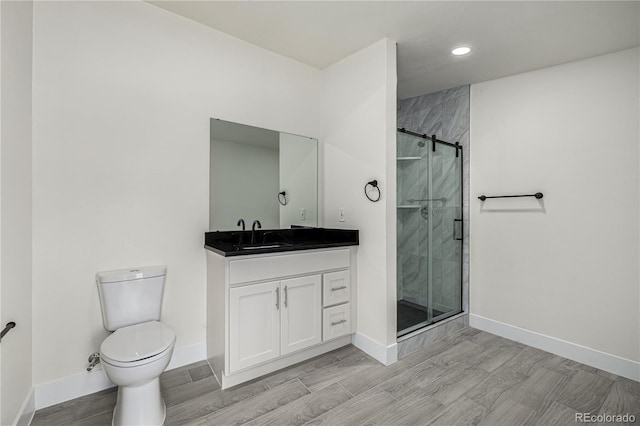 bathroom with vanity, toilet, and walk in shower