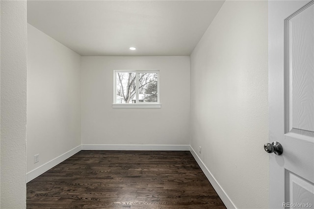 spare room with dark hardwood / wood-style flooring