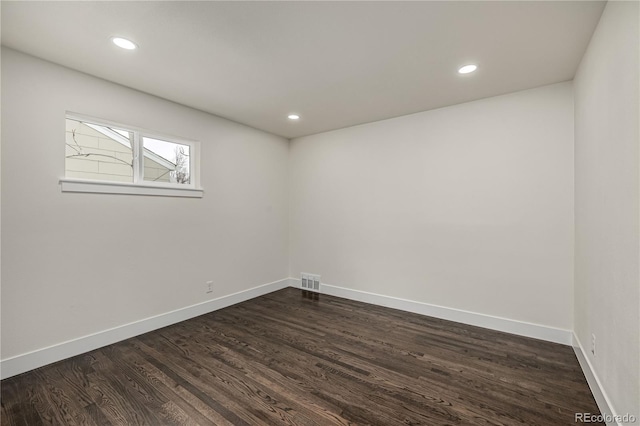 empty room featuring dark wood-type flooring