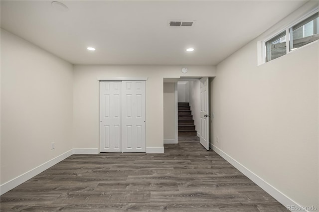 basement featuring dark hardwood / wood-style flooring