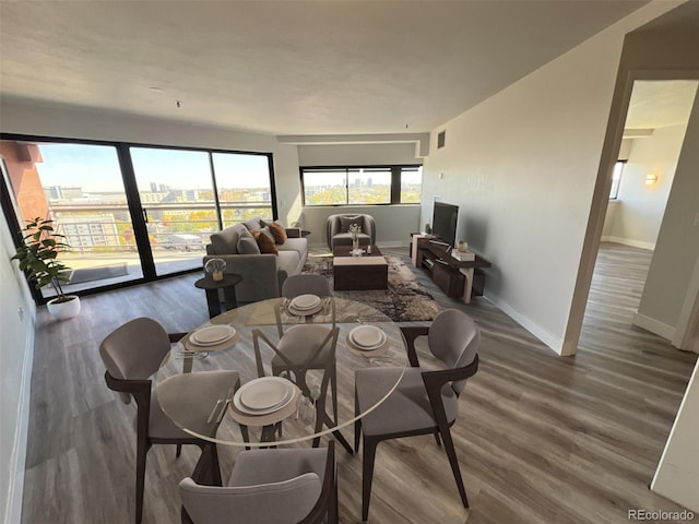 dining area featuring baseboards and dark wood finished floors