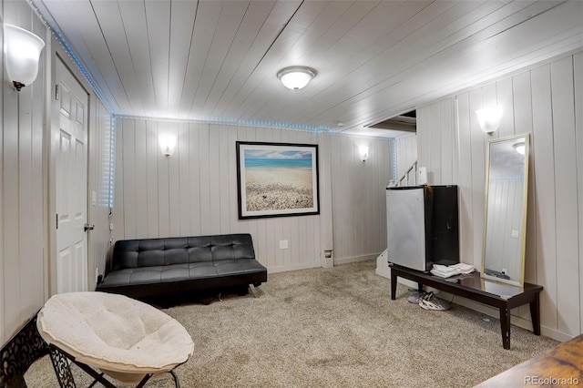 living area featuring wooden ceiling and carpet flooring